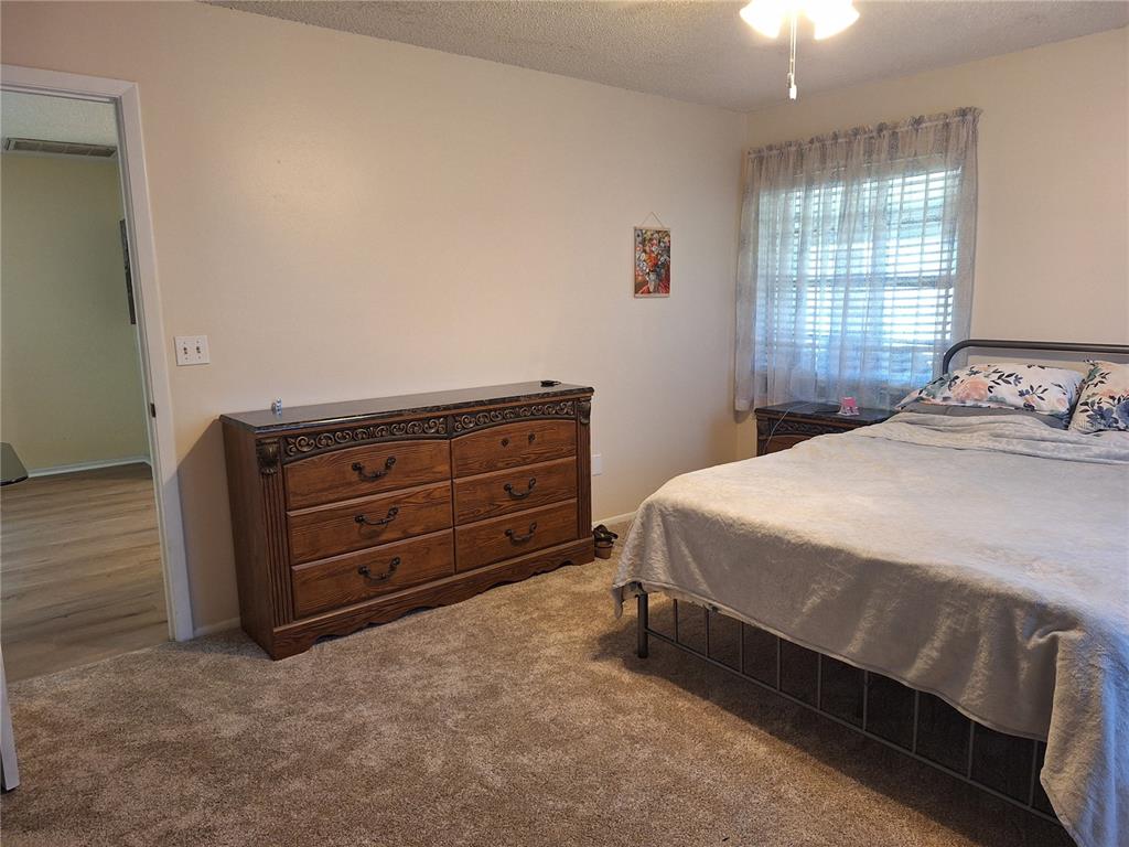 419 Falcon Avenue Edgewater, FL 32141 - Photo 3 of 8 a bedroom with a bed and window