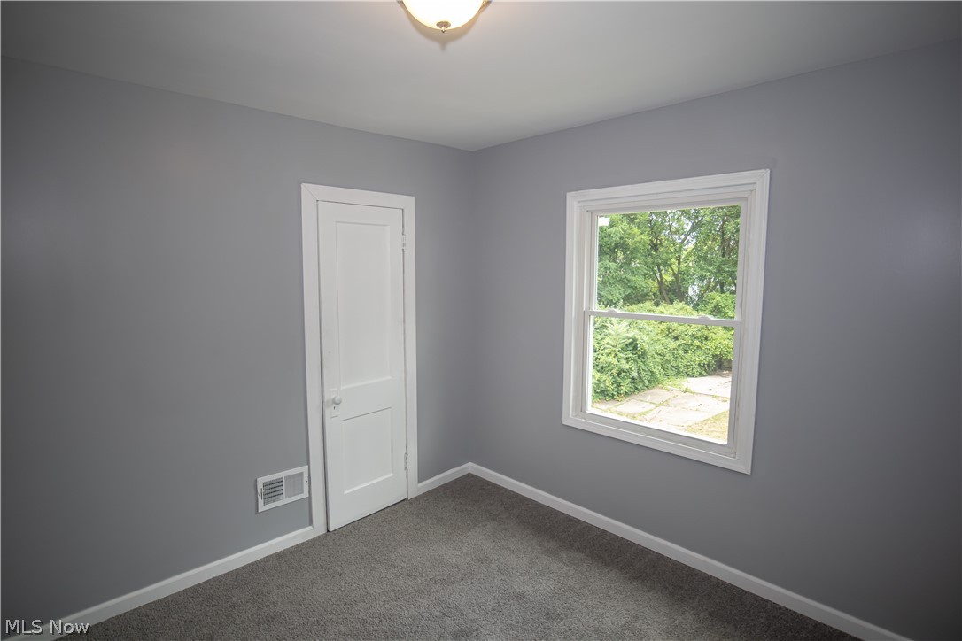 9505 Aetna Road Cleveland, OH 44105 - Photo 13 of 25 Carpeted spare room featuring a wealth of natural light
