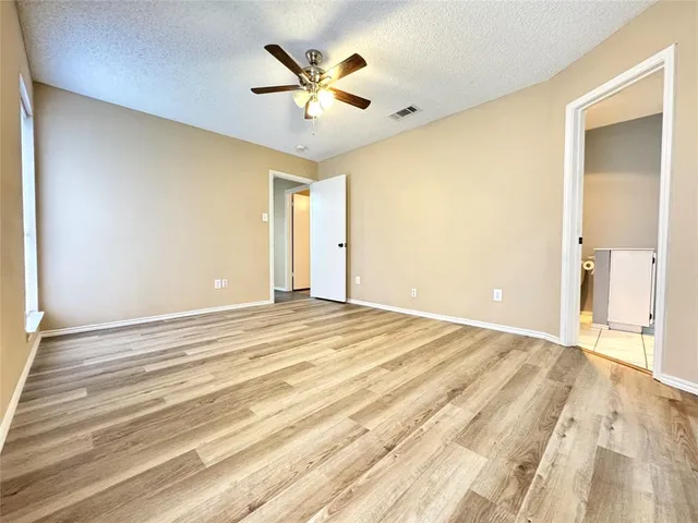 a view of a room with a ceiling fan