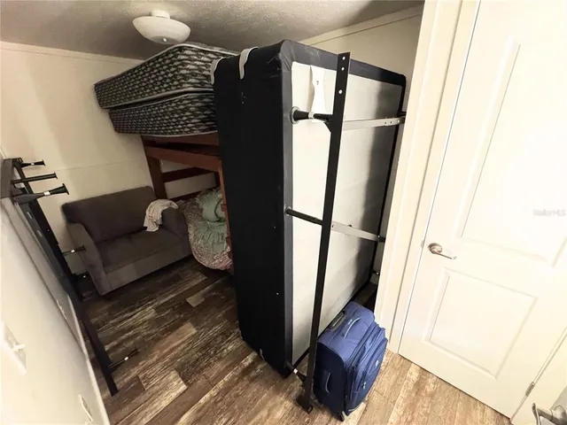a bed sitting in a bedroom next to a small bathroom