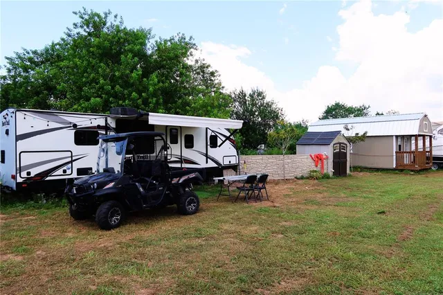 a view of a house with a small yard and wooden fence