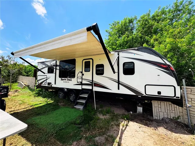 a living room with furniture a rug and a chandelier