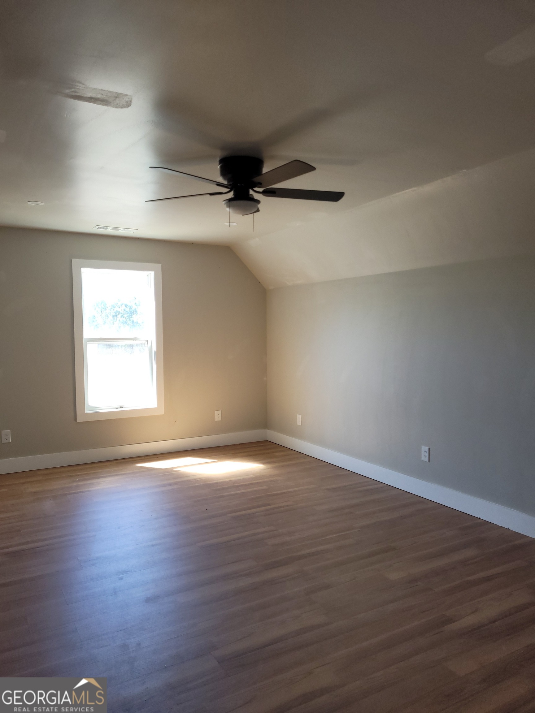2910 Battlecrest Drive Decatur, GA 30034 - Photo 11 of 12 a view of an empty room with wooden floor and a window