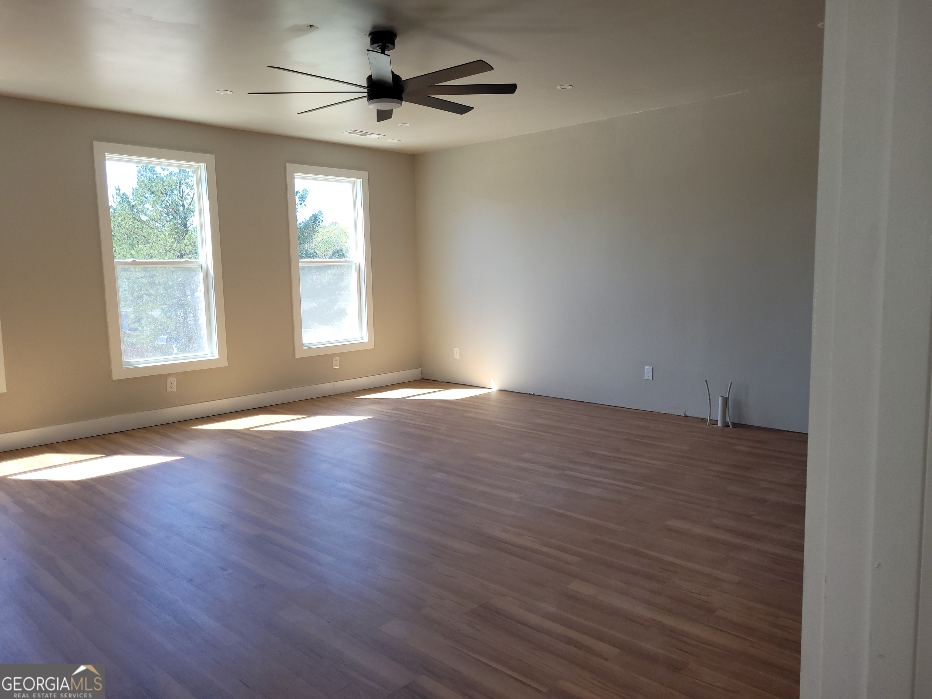 2910 Battlecrest Drive Decatur, GA 30034 - Photo 9 of 12 an empty room with wooden floor and windows