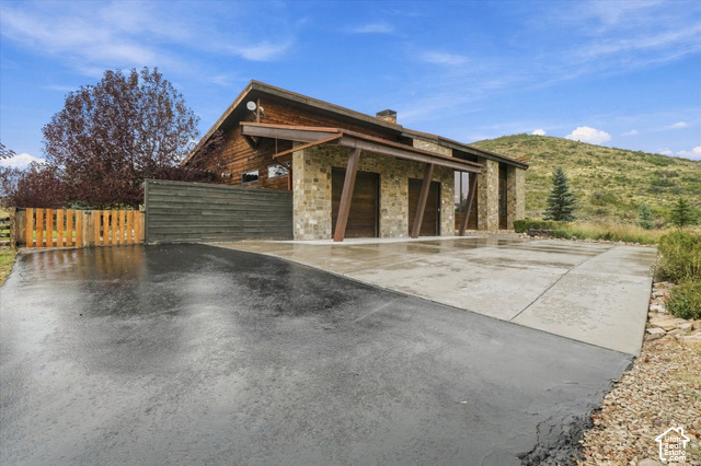 5936 Triple Crown Trail Oakley, UT 84055 - Photo 41 of 57 Stone and wood-clad exterior with an A-frame roofline and extended eaves