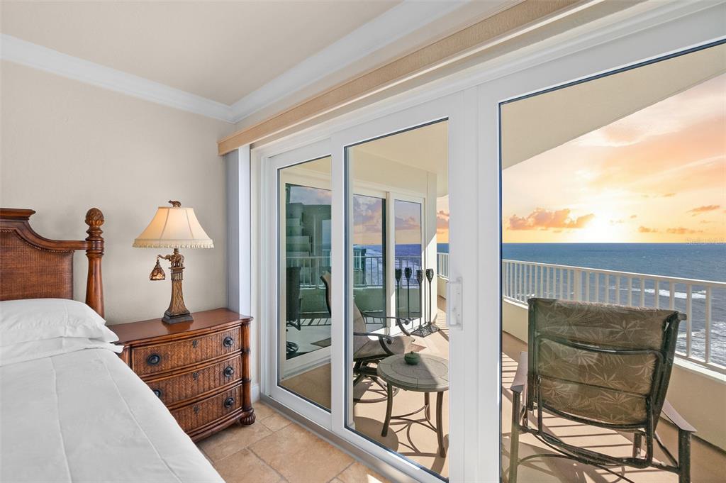 2937 South Atlantic Avenue, Unit 1907 Daytona Beach Shores, FL 32118 - Photo 14 of 55 a bedroom with furniture and large windows