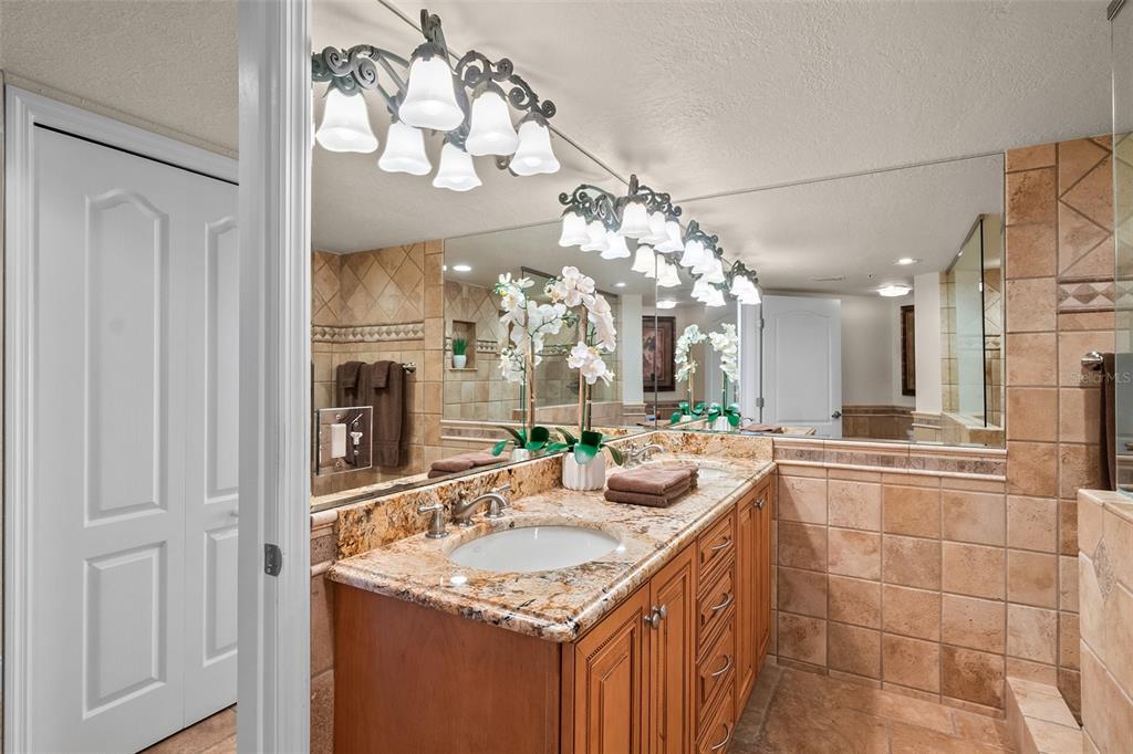 2937 South Atlantic Avenue, Unit 1907 Daytona Beach Shores, FL 32118 - Photo 19 of 55 a bathroom with a sink vanity and a mirror