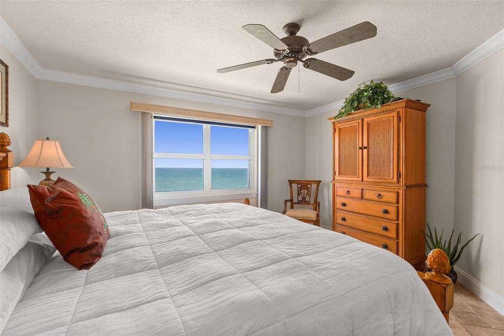 2937 South Atlantic Avenue, Unit 1907 Daytona Beach Shores, FL 32118 - Photo 23 of 55 a bedroom with a bed and a large window