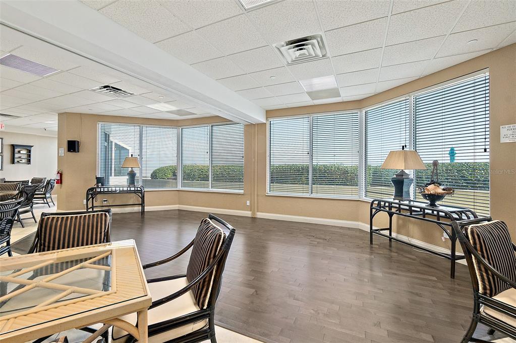 2937 South Atlantic Avenue, Unit 1907 Daytona Beach Shores, FL 32118 - Photo 52 of 55 a dining room with furniture large windows and wooden floor