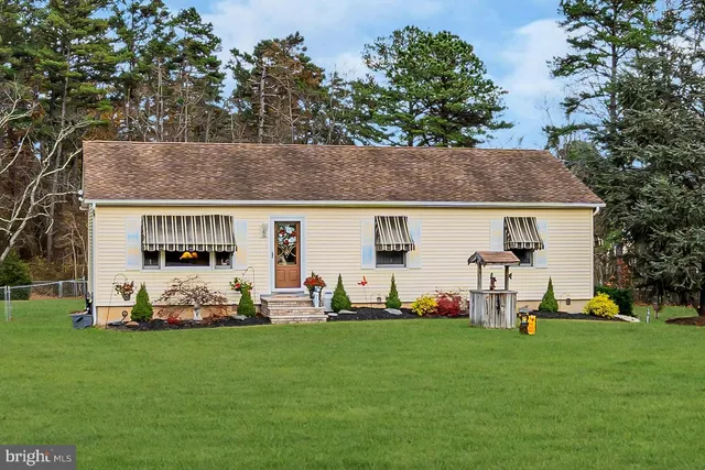 a front view of house with yard and outdoor seating