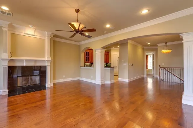a view of a room wooden floor and a kitchen