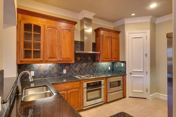 a kitchen with granite countertop a sink and cabinets