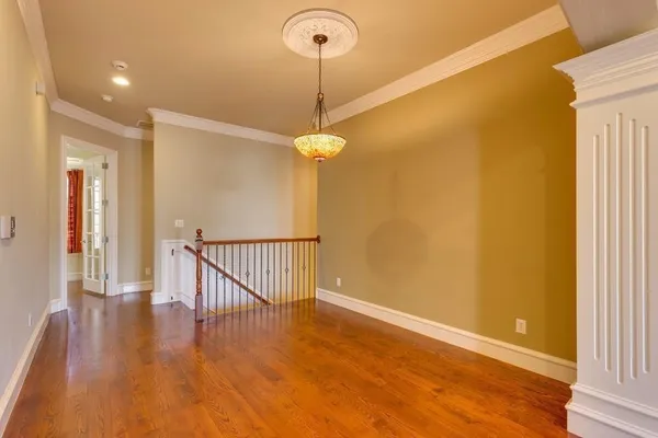 a view of a room with wooden floor