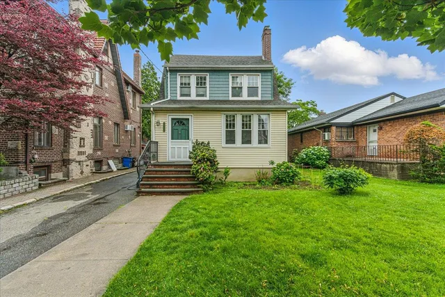 a front view of a house with garden