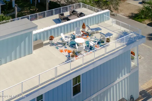 a kitchen with stainless steel appliances granite countertop a table chairs stove and white cabinets