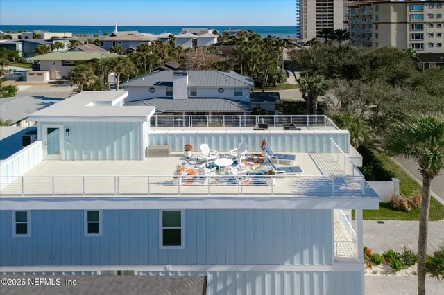a kitchen with granite countertop a refrigerator a stove and white cabinets