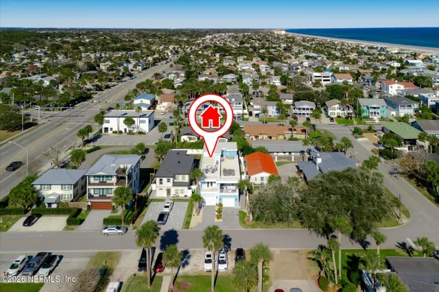 a kitchen with a dining table cabinets appliances and wooden floor
