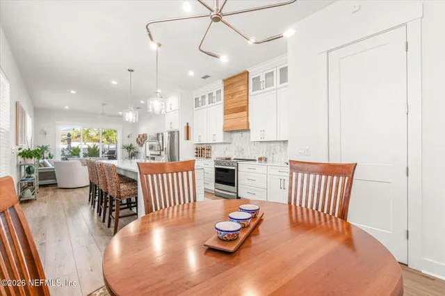a large kitchen with stainless steel appliances granite countertop a lot of counter space and wooden floors