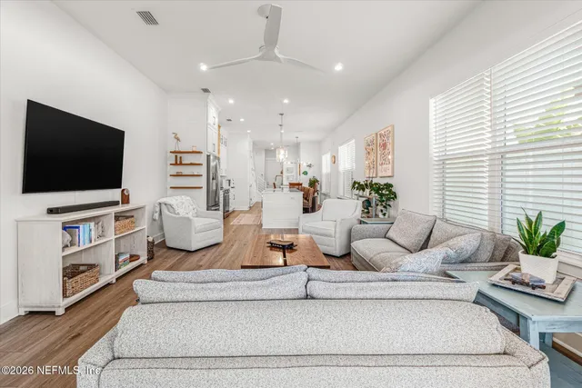 a spacious bedroom with a bed and a dresser