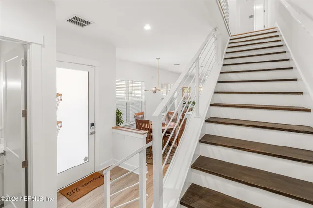 a spacious bathroom with double sink and a large mirror