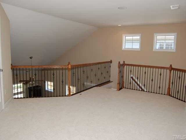 6227 Oconner Street Raleigh, NC 27617 - Photo 7 of 11 Neutral carpet, designer neutral wall paint, overhead light, built in speakers, walk in storage access, smooth ceiling Loft
