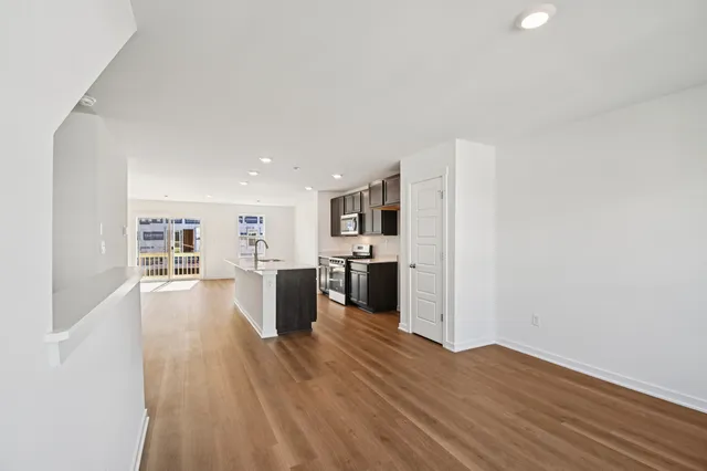 a view of a kitchen with wooden floor