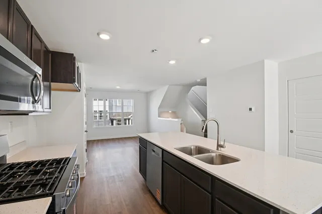 a kitchen with a sink stove and microwave