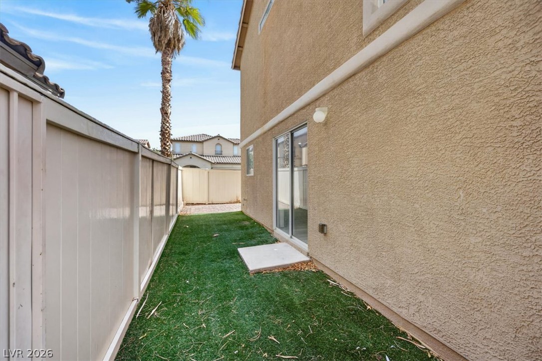 552 Albacate Street Henderson, NV 89015 - Photo 39 of 40 A neatly maintained private yard offers a tranquil outdoor retreat with artificial turf and secure fencing.