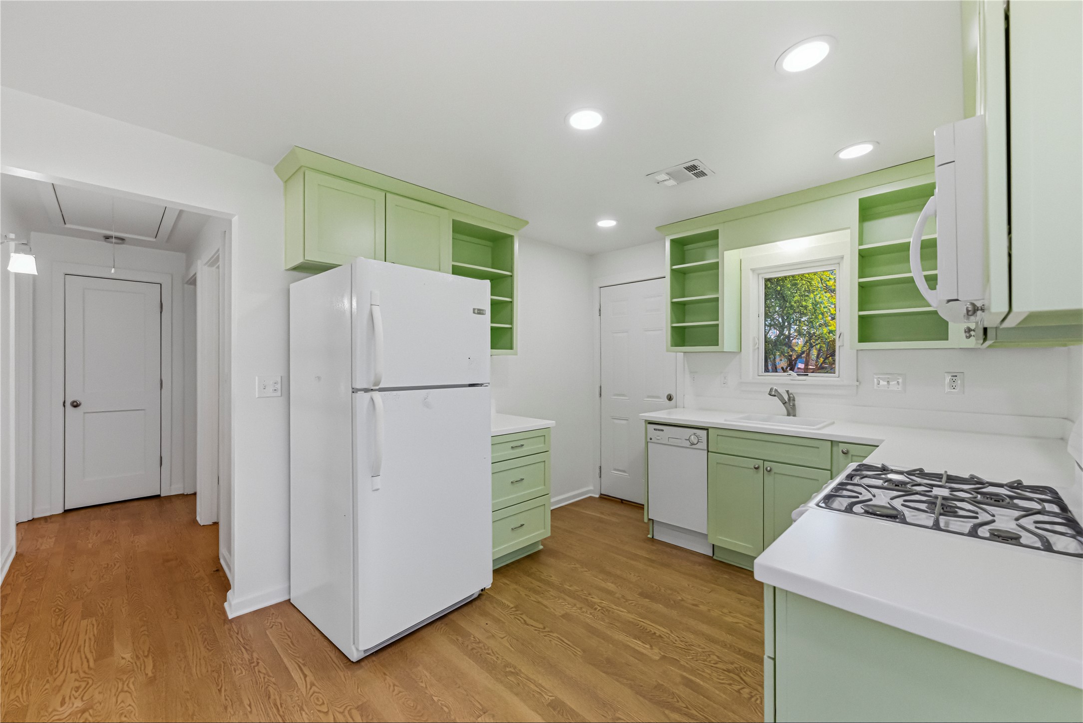 503 West Croslin Street Austin, TX 78752 - Photo 12 of 24 a kitchen with a refrigerator a sink and a stove top oven