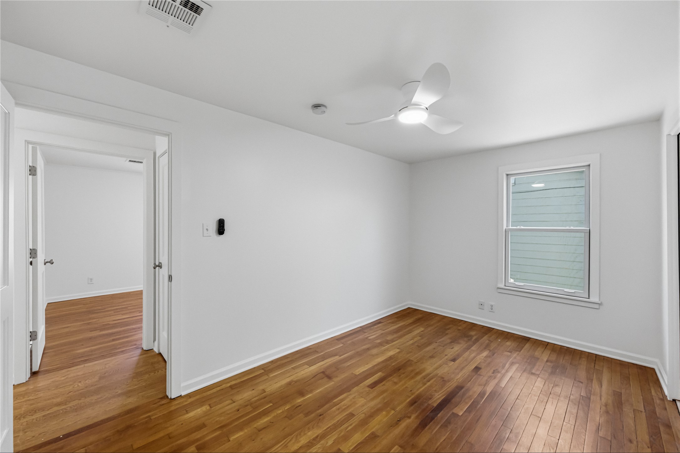 503 West Croslin Street Austin, TX 78752 - Photo 16 of 24 an empty room with wooden floor and windows