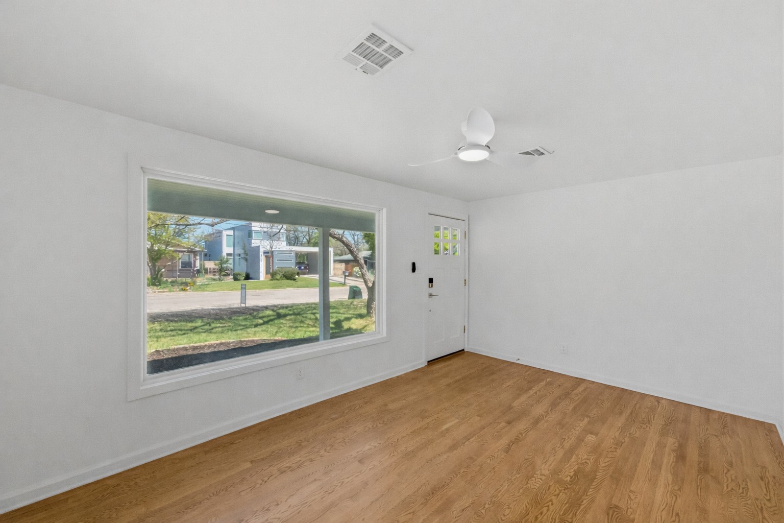 503 West Croslin Street Austin, TX 78752 - Photo 5 of 24 an empty room with wooden floor and windows
