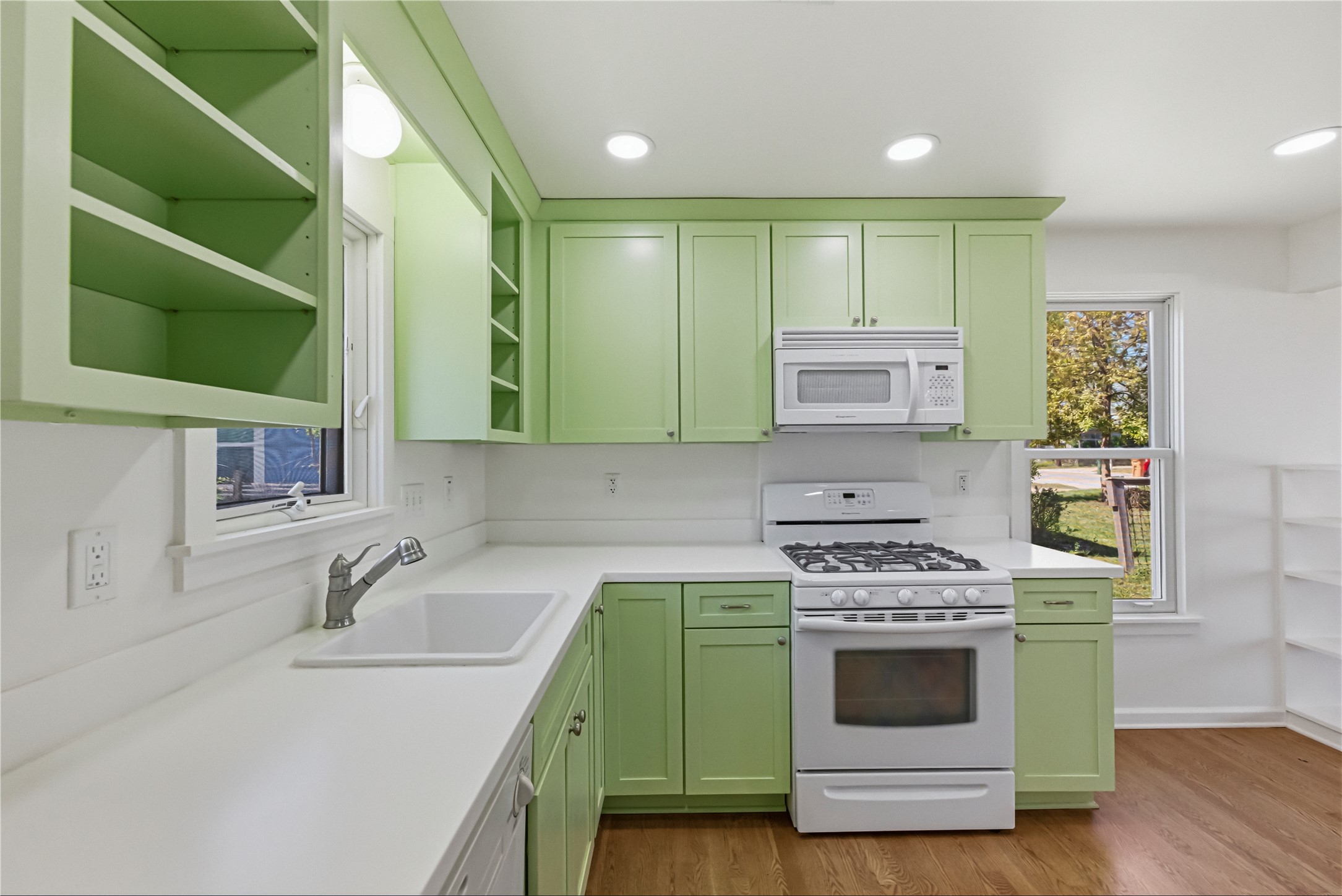 503 West Croslin Street Austin, TX 78752 - Photo 8 of 24 a kitchen with cabinets a sink and a stove top oven