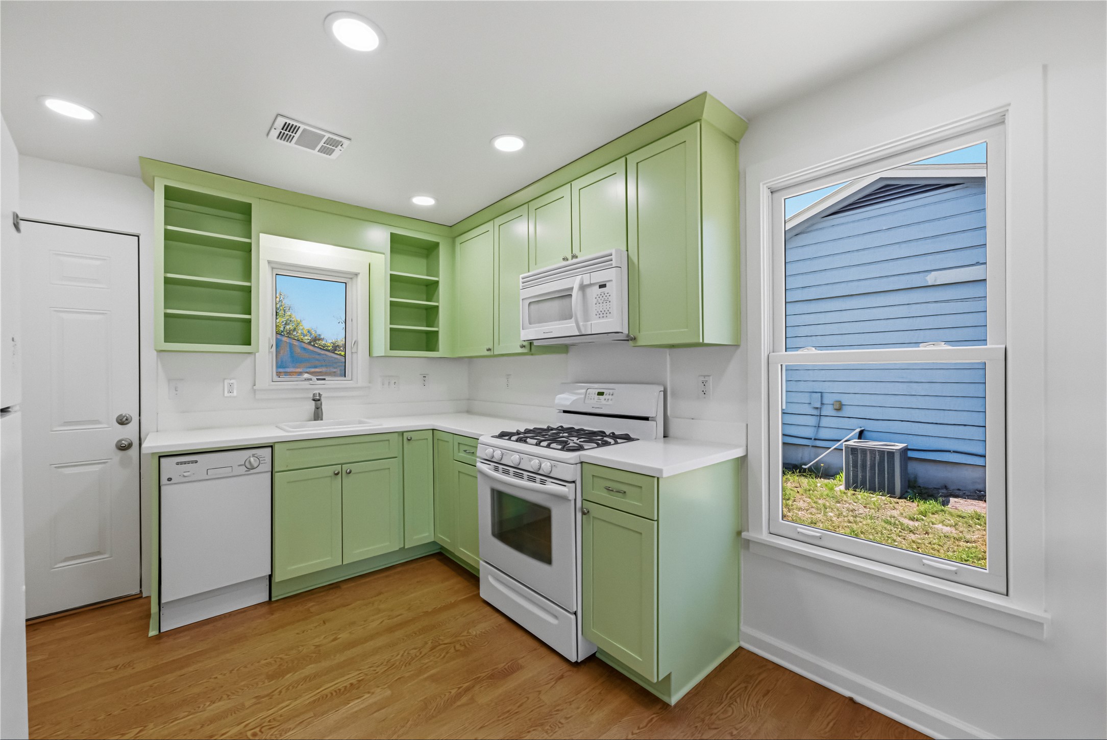 503 West Croslin Street Austin, TX 78752 - Photo 9 of 24 a kitchen with a stove a sink and a window
