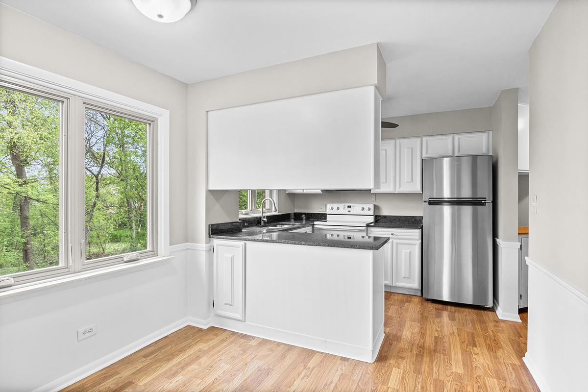 2420 West Talcott Road, Unit 211 Park Ridge, IL 60068 - Photo 11 of 28 a kitchen with a stove a sink and a refrigerator