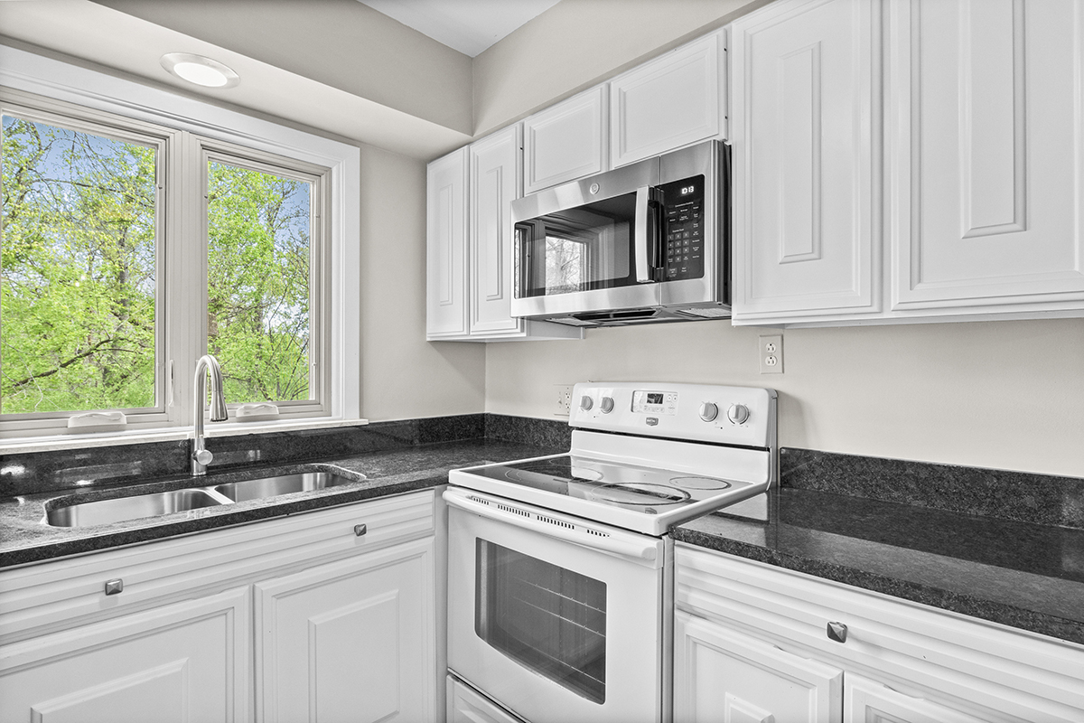 2420 West Talcott Road, Unit 211 Park Ridge, IL 60068 - Photo 13 of 28 a kitchen with stainless steel appliances granite countertop white cabinets and a stove top oven