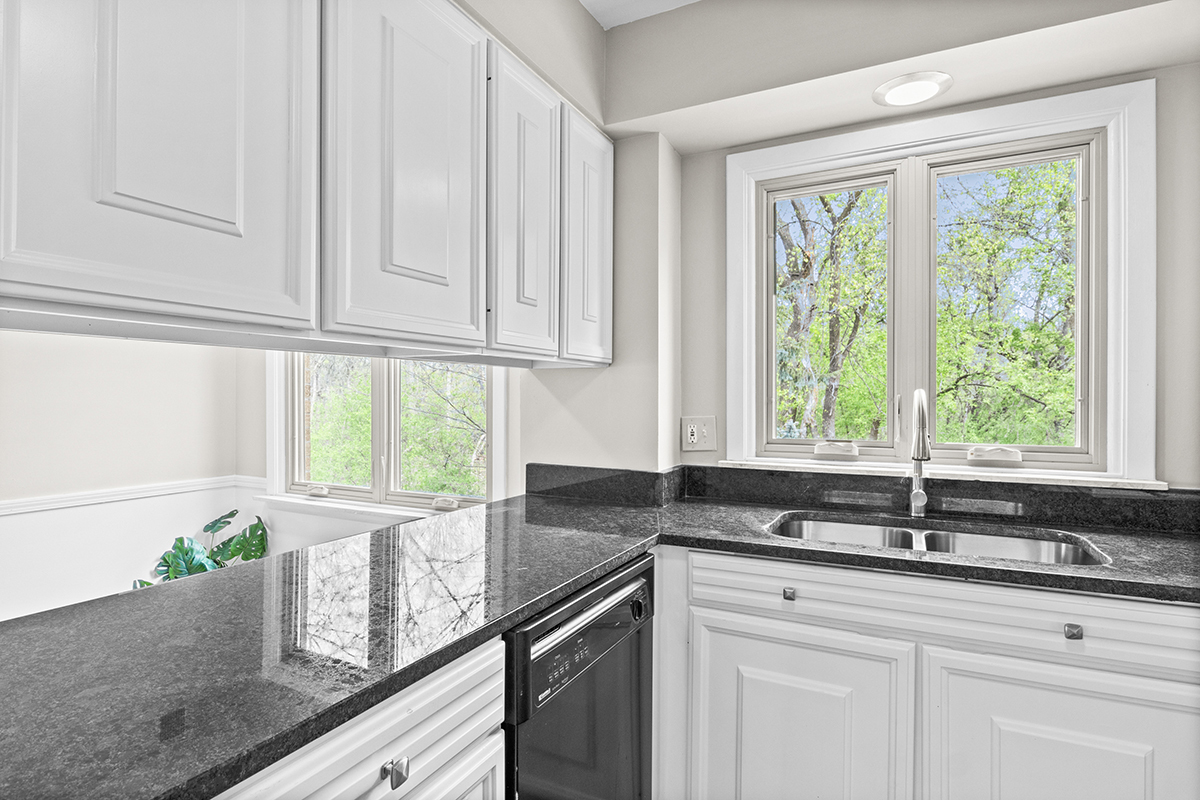 2420 West Talcott Road, Unit 211 Park Ridge, IL 60068 - Photo 14 of 28 a kitchen with granite countertop a sink window and cabinets