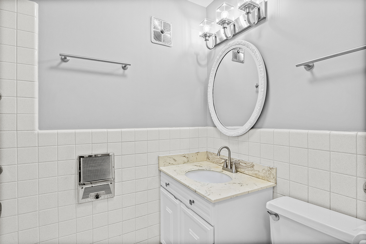 2420 West Talcott Road, Unit 211 Park Ridge, IL 60068 - Photo 21 of 28 a bathroom with a sink a toilet and a mirror