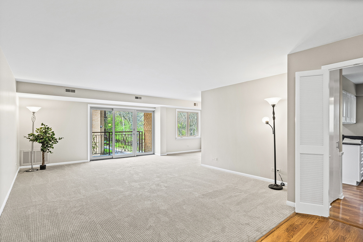 2420 West Talcott Road, Unit 211 Park Ridge, IL 60068 - Photo 4 of 28 a view of a livingroom with a potted plant and windows