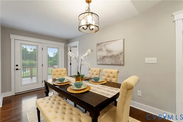 a view of a dining room with furniture wooden floor and a chandelier
