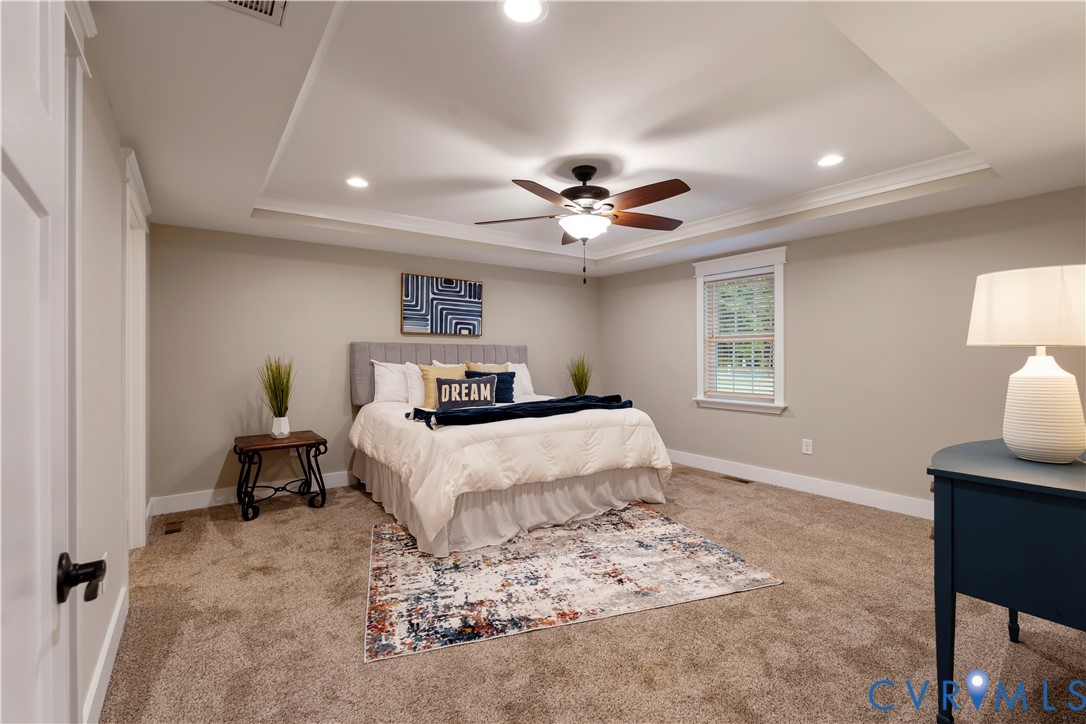12442 Quaker Road Dinwiddie, VA 23841 - Photo 19 of 28 Owners suite carpeted bedroom featuring a raised c