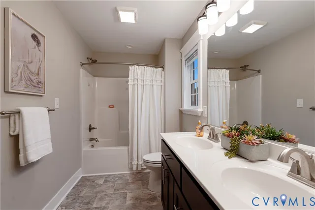 a bathroom with a sink vanity granite tub shower and a mirror