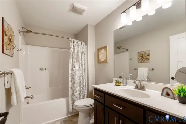 a bathroom with a sink a toilet a mirror a bathtub and shower