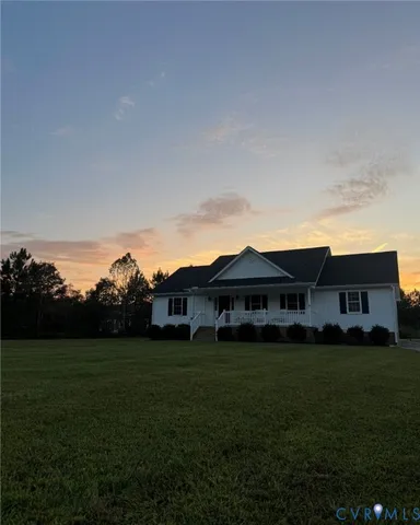 a view of a large garden with plants and large trees