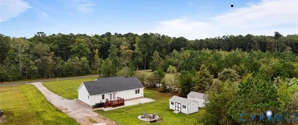 a view of a chairs and table in the backyard