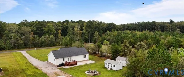 a view of a chairs and table in the backyard