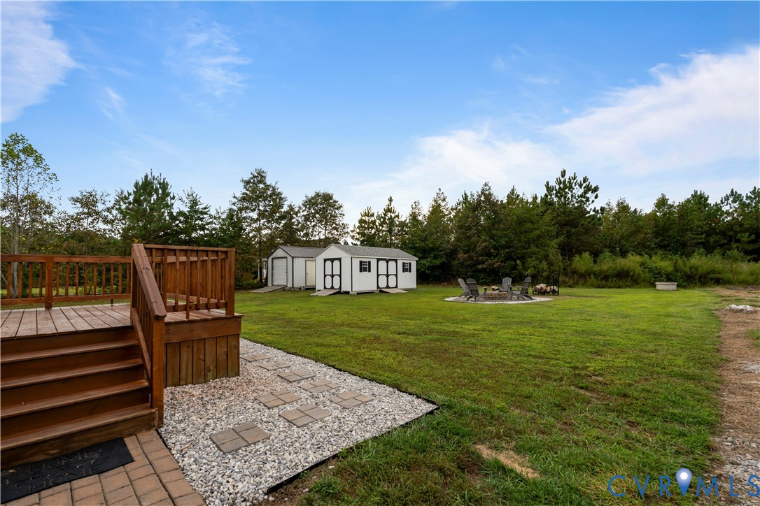 12442 Quaker Road Dinwiddie, VA 23841 - Photo 9 of 28 View of grassy yard with a patio area, a fire pit,