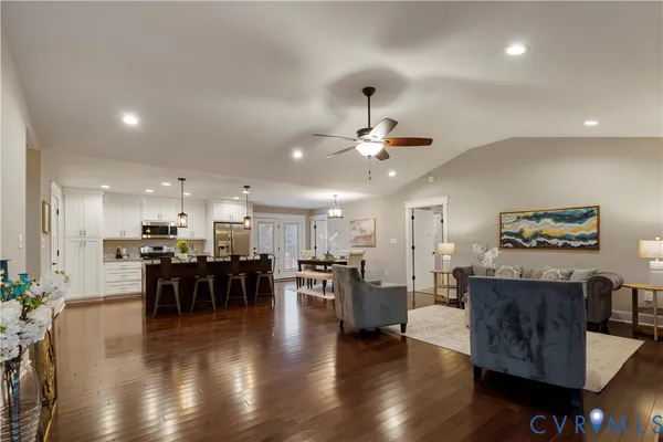 a view of a dining room with furniture wooden floor and chandelier