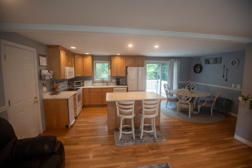 18 Birchwood Road Rutland, MA 01543 - Photo 14 of 42 a kitchen with stainless steel appliances kitchen island granite countertop a dining table chairs and granite counter tops