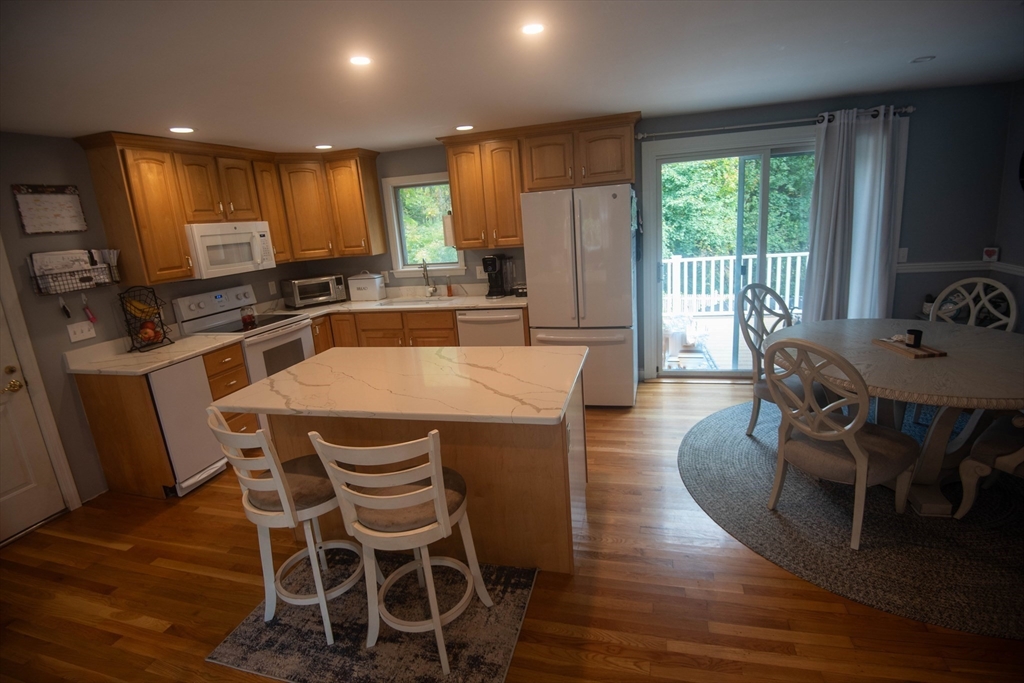 18 Birchwood Road Rutland, MA 01543 - Photo 19 of 42 a kitchen with a table chairs sink and microwave