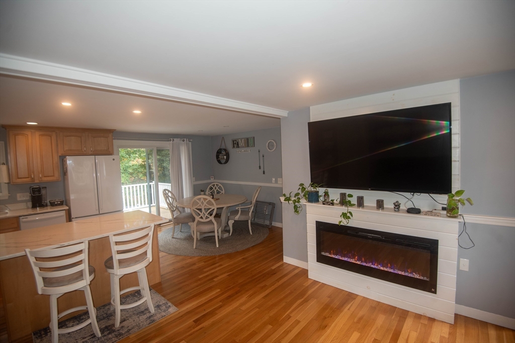 18 Birchwood Road Rutland, MA 01543 - Photo 23 of 42 a living room with furniture a flat screen tv and floor to ceiling window